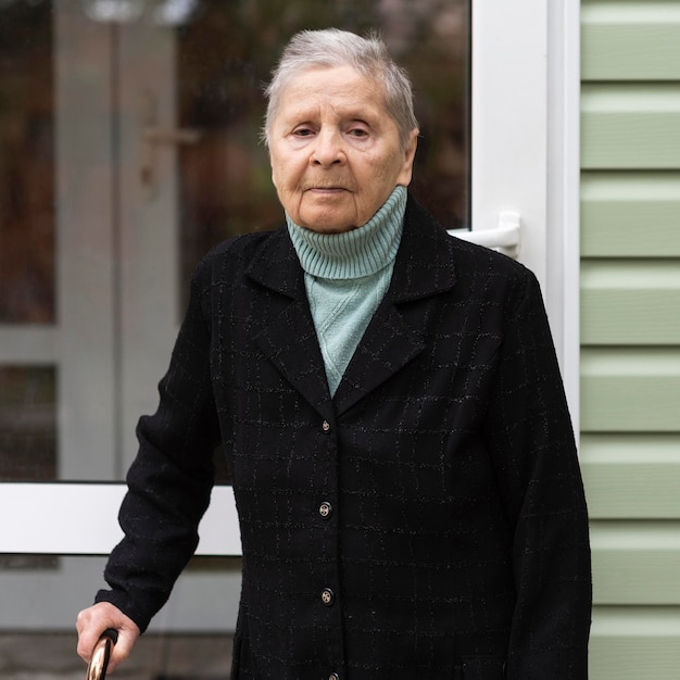 Free Photo front view of older woman with cane at nursing home