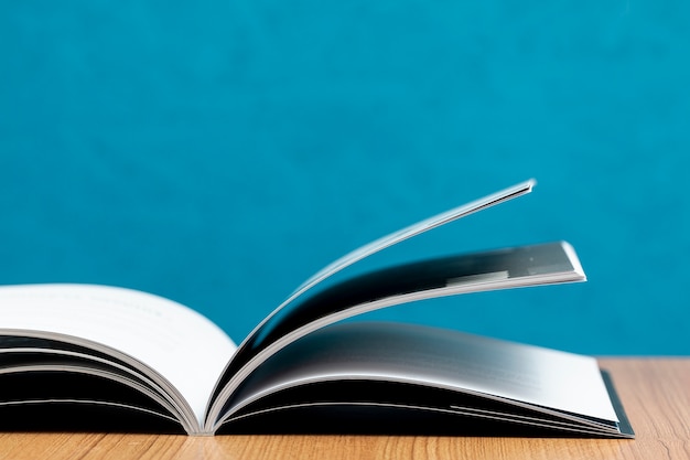 Front view open book on wooden table