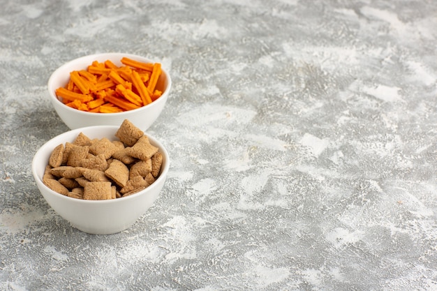 Front view orange rusks with pillow cookies on the white desk