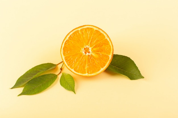 A front view orange slice fresh mellow juicy ripe isolated along with green leaves on the cream colored background citrus fruit juice summer