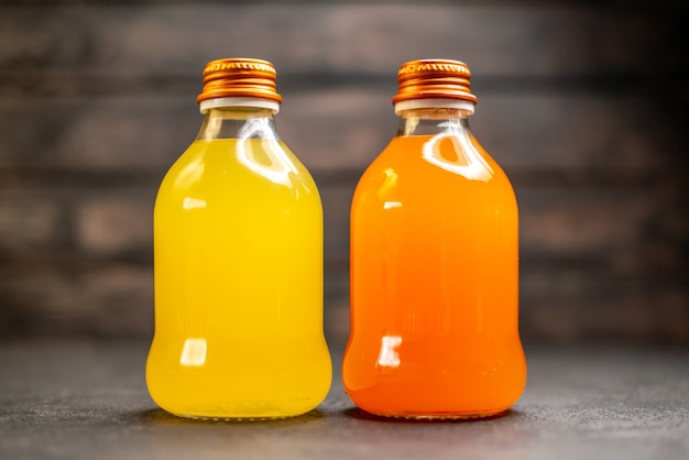 Free photo front view orange and yellow juice