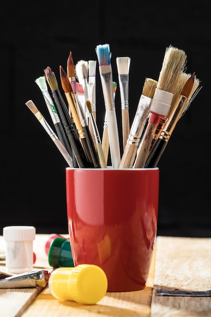 Free photo front view of paint brushes in cup