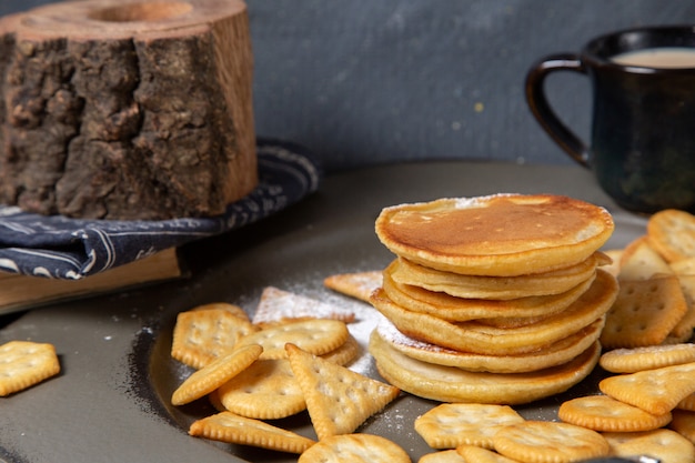 Front view pancakes and crisps with milk on grey