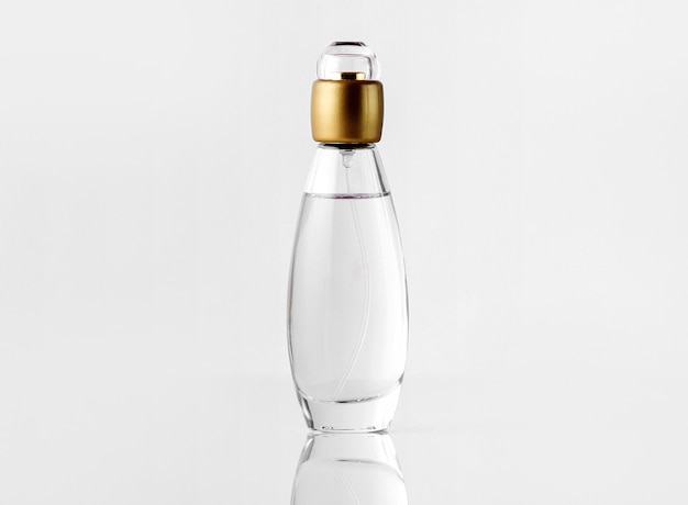 Free Photo a front view parfume inside bottle with golden cap on the white