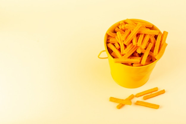 Free photo a front view pasta inside basket formed orange raw inside yellow basket on the cream background meal food pasta