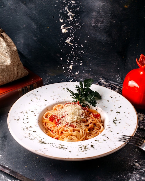 Front view pasta tasty yummy spicy with red tomatoes and green leaf on the bright floor