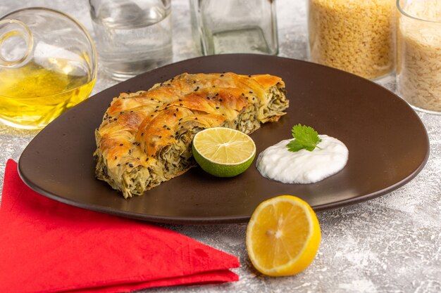 Front view pastry with meat delicious dough meal inside plate with lemon oil on white light desk.