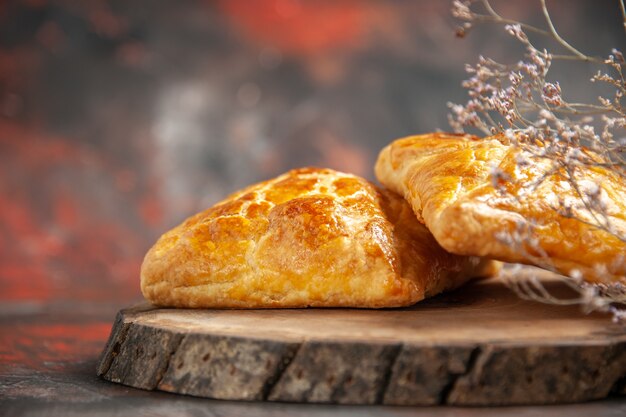 Front view penovani khachapuri on wood board on dark red table