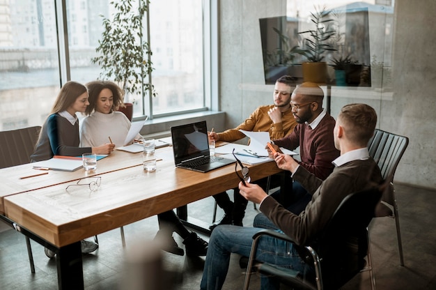 Front view of people having a meeting in the office