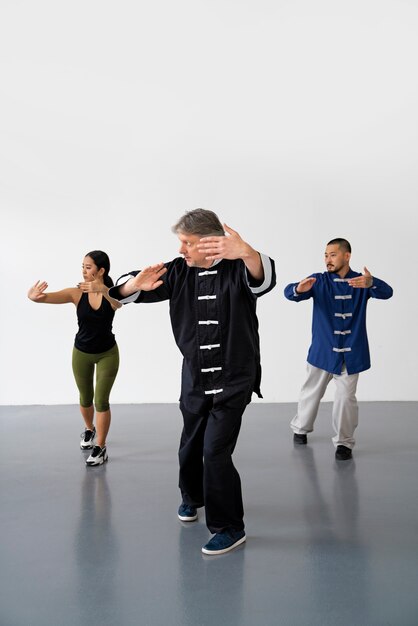 Front view people practicing tai chi together