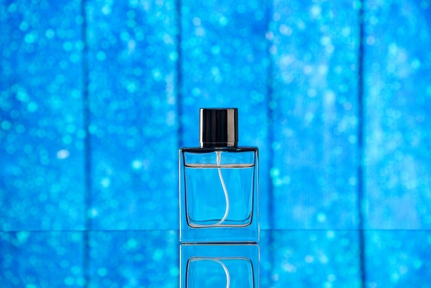 Free photo front view of perfume bottle on blue