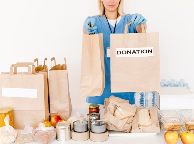 Free Photo front view of person handing out donation bags