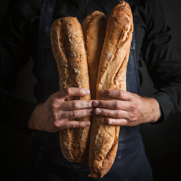 Free photo front view person holding bread