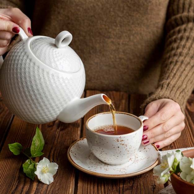 Front view of a person pouring tea concept