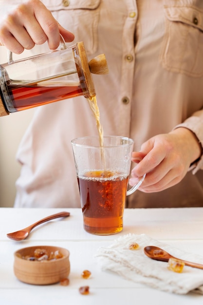 Free Photo front view of person preparing tea