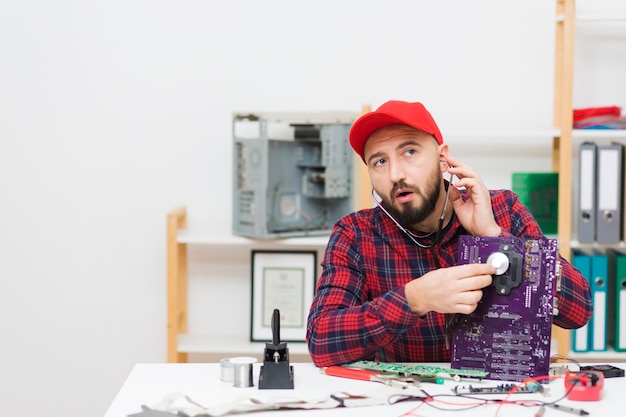 Free photo front view person repairing a motherboard