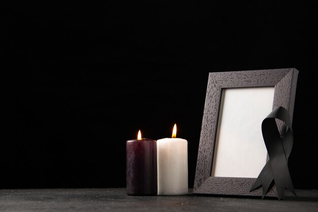 Front view of picture frame with candles on black