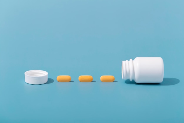 Front view of pills in row with container