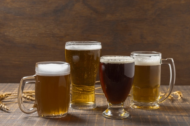 Front view pint and glasses with beer on table