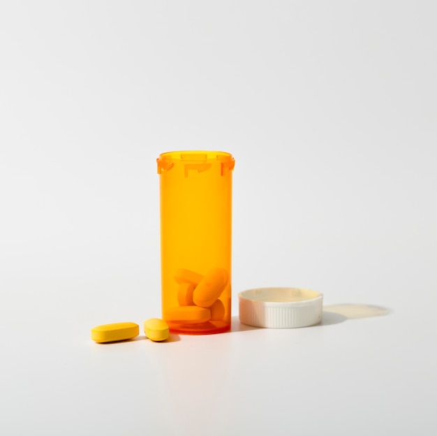 Free photo front view of plastic container with pills