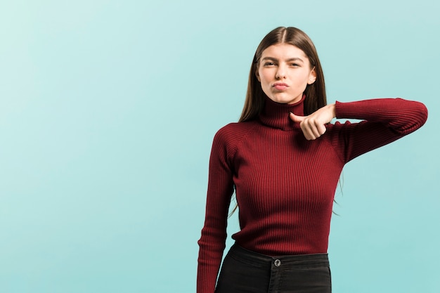 Front view pointing woman in studio