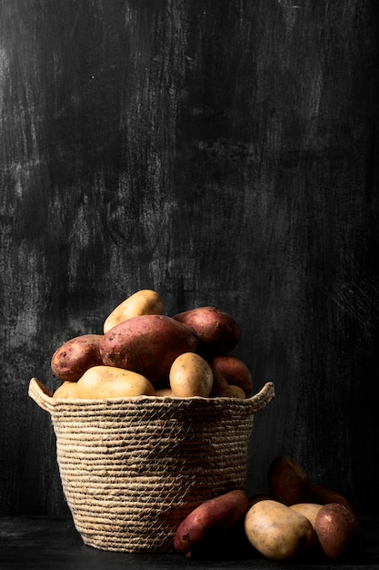 Free photo front view potatoes in basket with copy space