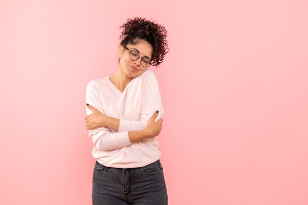 Front view of pretty female delighted on pink