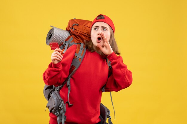 Front view pretty female hiker with backpack holding credit card calling someone