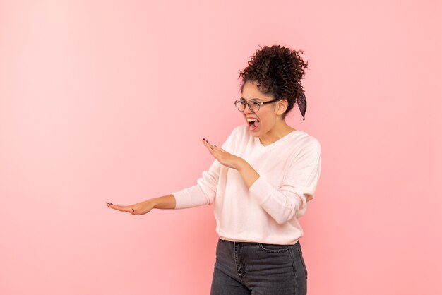 Front view of pretty female screaming on pink