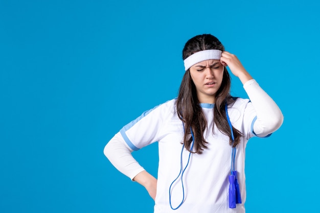 Front view pretty female in sport clothes with skipping rope