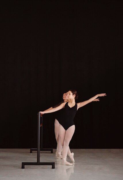 Front view of professional ballerinas rehearsing together with copy space