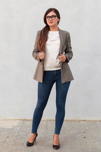 Front view of professional businesswoman posing outdoors