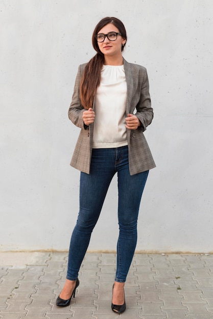 Front view of professional businesswoman posing outdoors