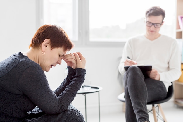 Free Photo front view of psychologist consulting a patient