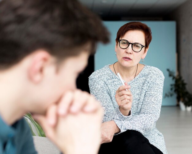 Front view of psychologist giving advices to patient