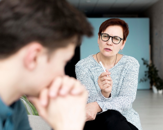 Front view of psychologist giving advices to patient