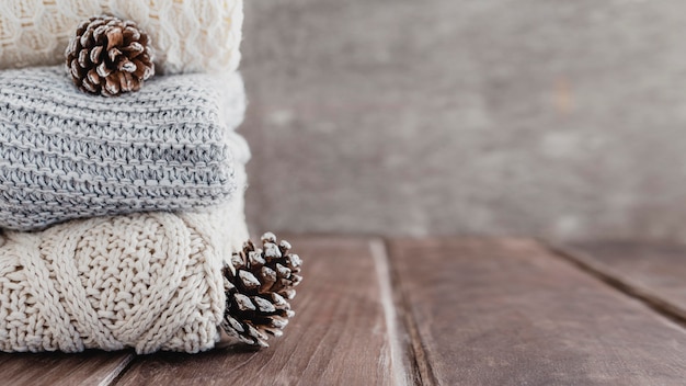 Front view pullovers and pine cones with copy-space