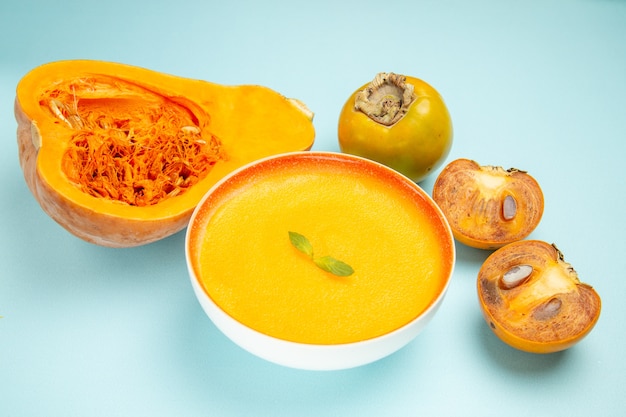 Front view pumpkin soup with fresh pumpkins on the blue table dish color soup