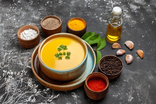 Front view pumpkin soup with seasonings on a dark table smooth thanksgiving dine