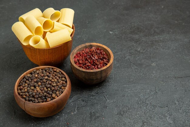 Front view raw italian pasta with seasonings