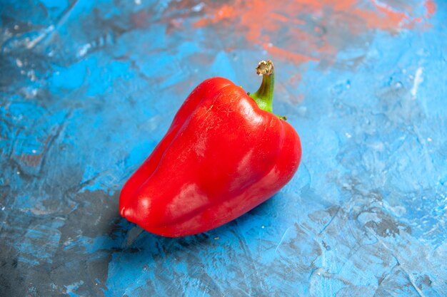 Front view red bell-pepper on the blue table color photo food salad vegetable