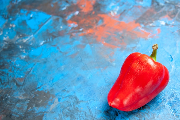 Front view red bell-pepper on a blue table