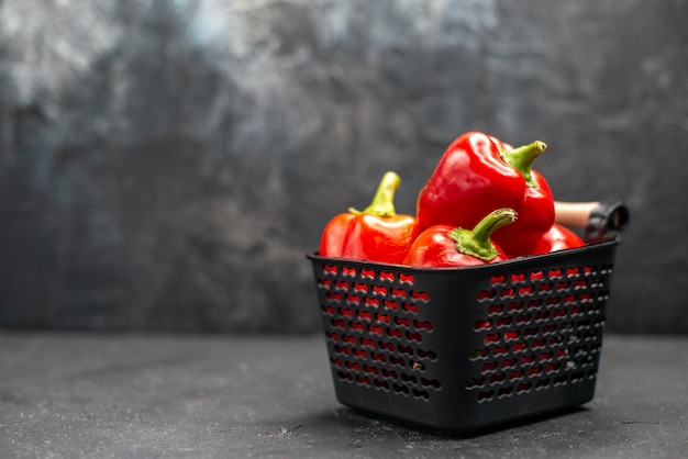 Free photo front view red bell-peppers spicy vegetables on dark desk