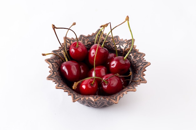 Front view red sour cherries inside plate on white fruit juice mellow