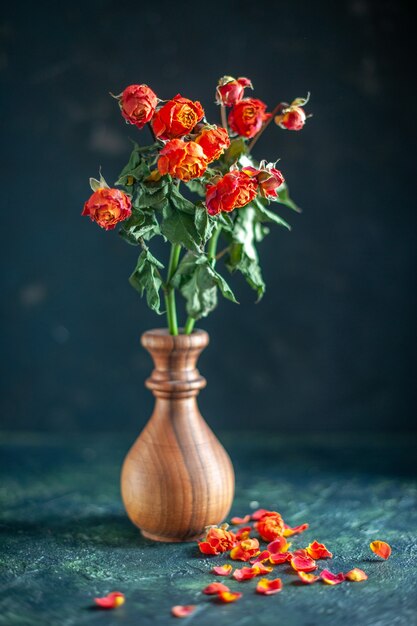 Front view red withered flowers on the dark surface