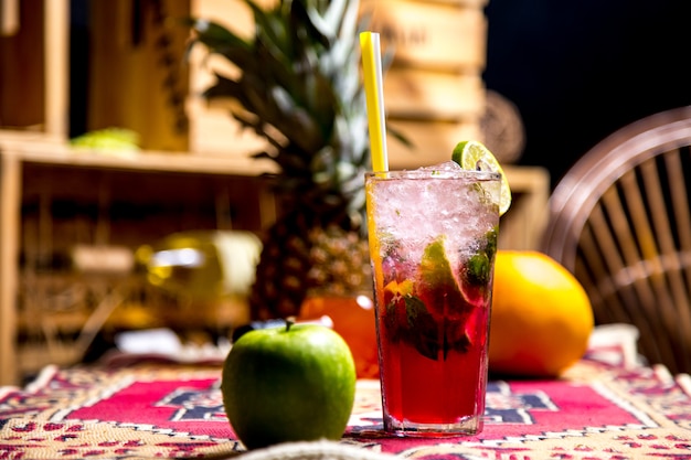 Front view refreshing lemonade with a slice of lime and a green apple