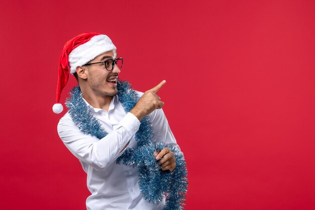 Front view regular male celebrating new year on a red wall human holiday christmas