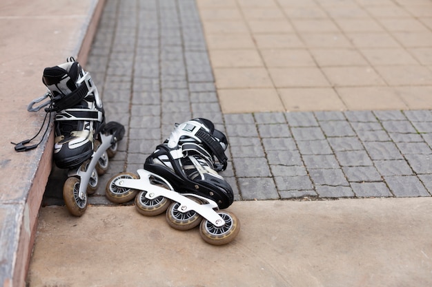 Free Photo front view of roller blades on pavement with copy space