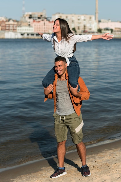 Front view of romantic couple spending time at the beach