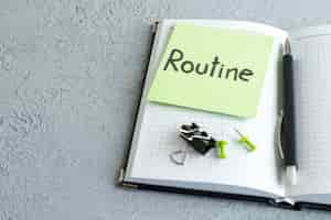 Free photo front view routine written note on green sticker with notepad and pen on white background